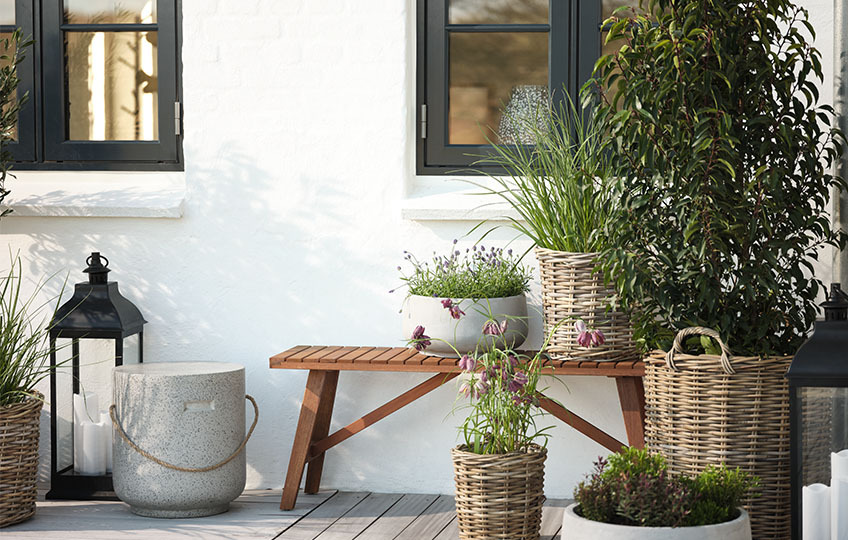 Woven rattan garden planters on deck