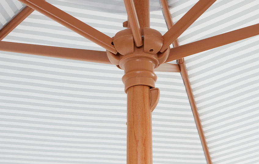 Close-up of the pole and underside of a garden parasol with metal foil decorative covering