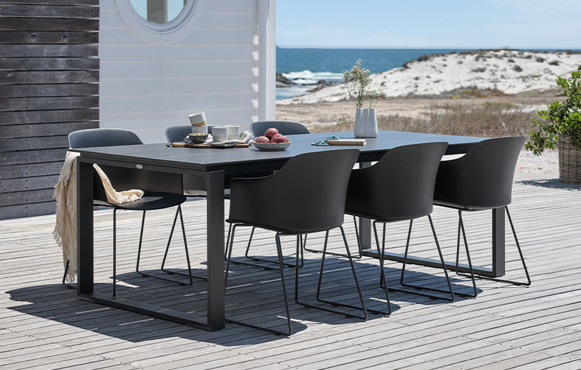 Large garden table and chairs on patio by the beach 