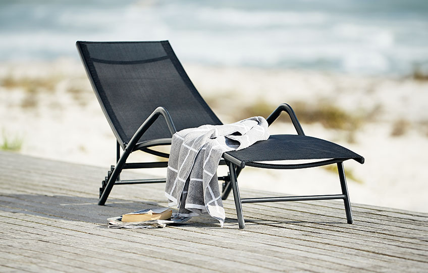 Outdoor sun  lounger with grey throw