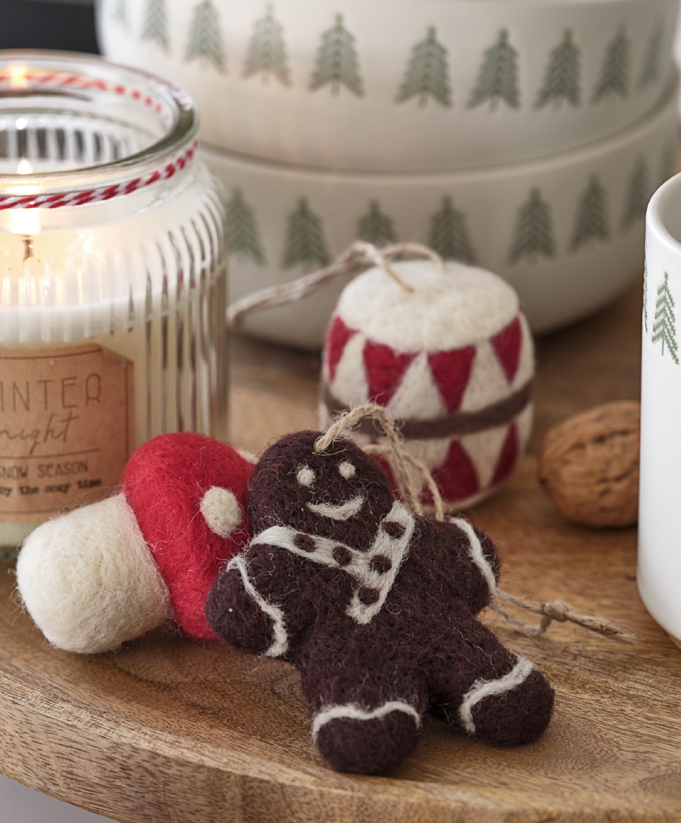 Felt Christmas tree decorations shaped like a gingerbread man, drum, and mushroom