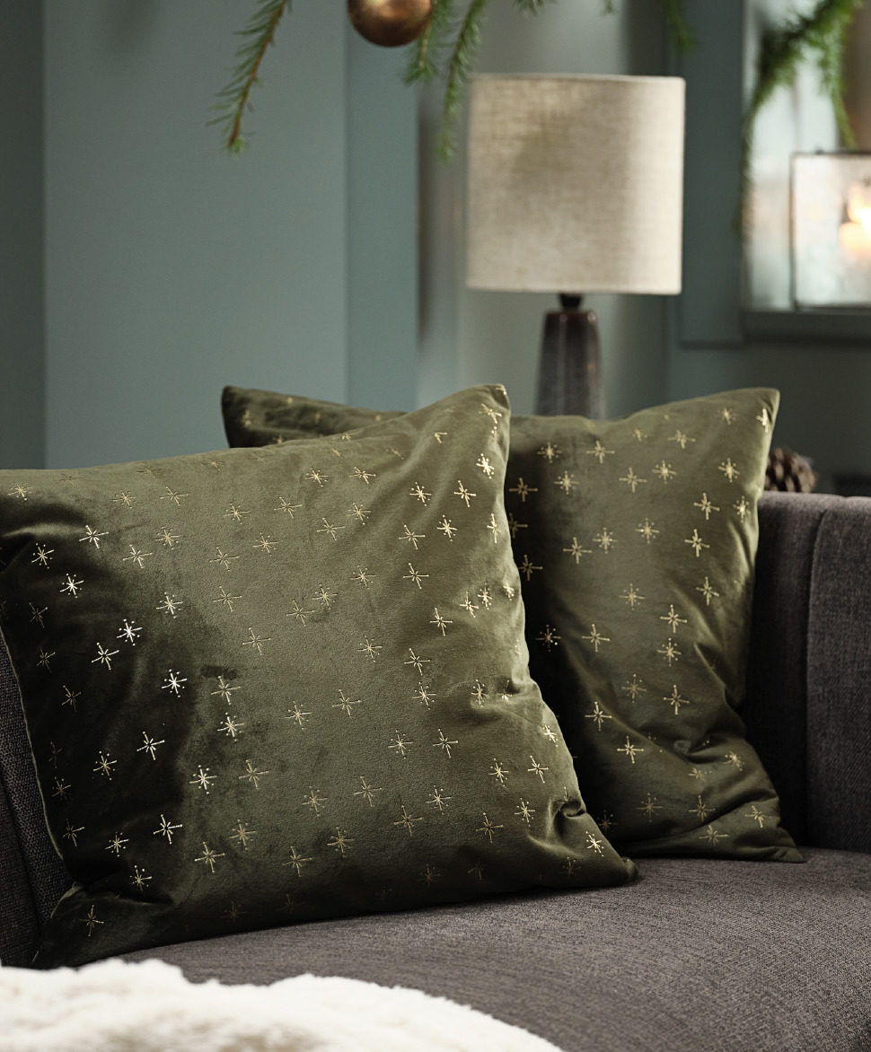 Green decorative cushion with gold stars