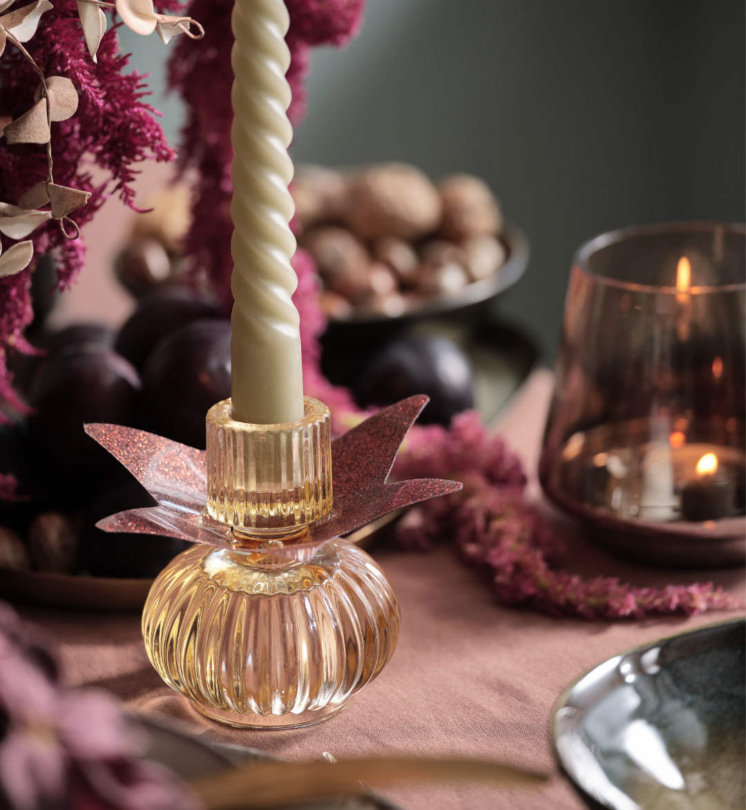 Glass candlestick with a twisted candle