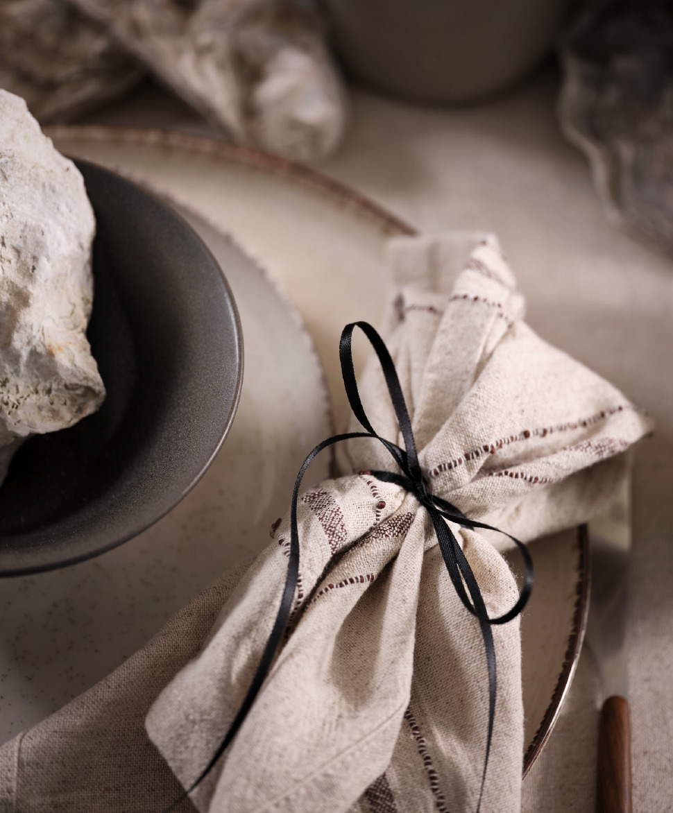 A fabric napkin tied together with a beautiful silk ribbon 