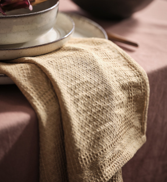 A yellow cloth napkin adds color to the table setting