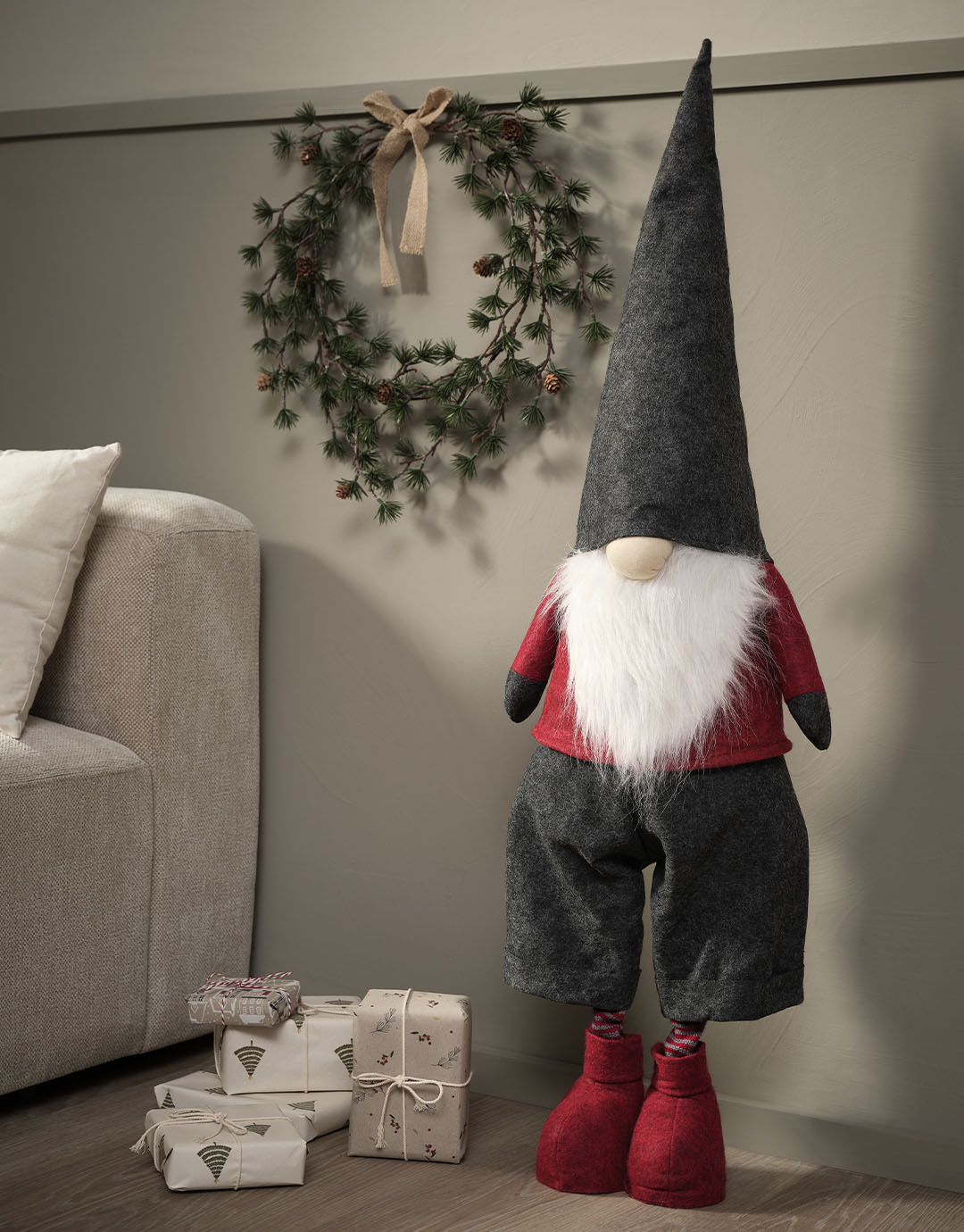 Scandinavian Christmas elf with button nose, white beard, and grey hat