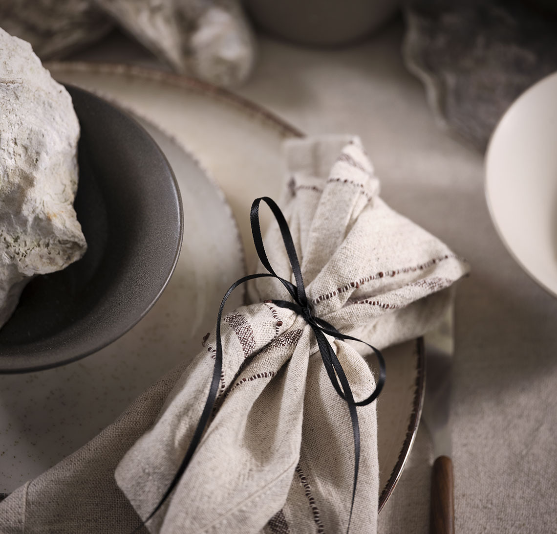 Place setting with plates, bowl and a cloth napkin