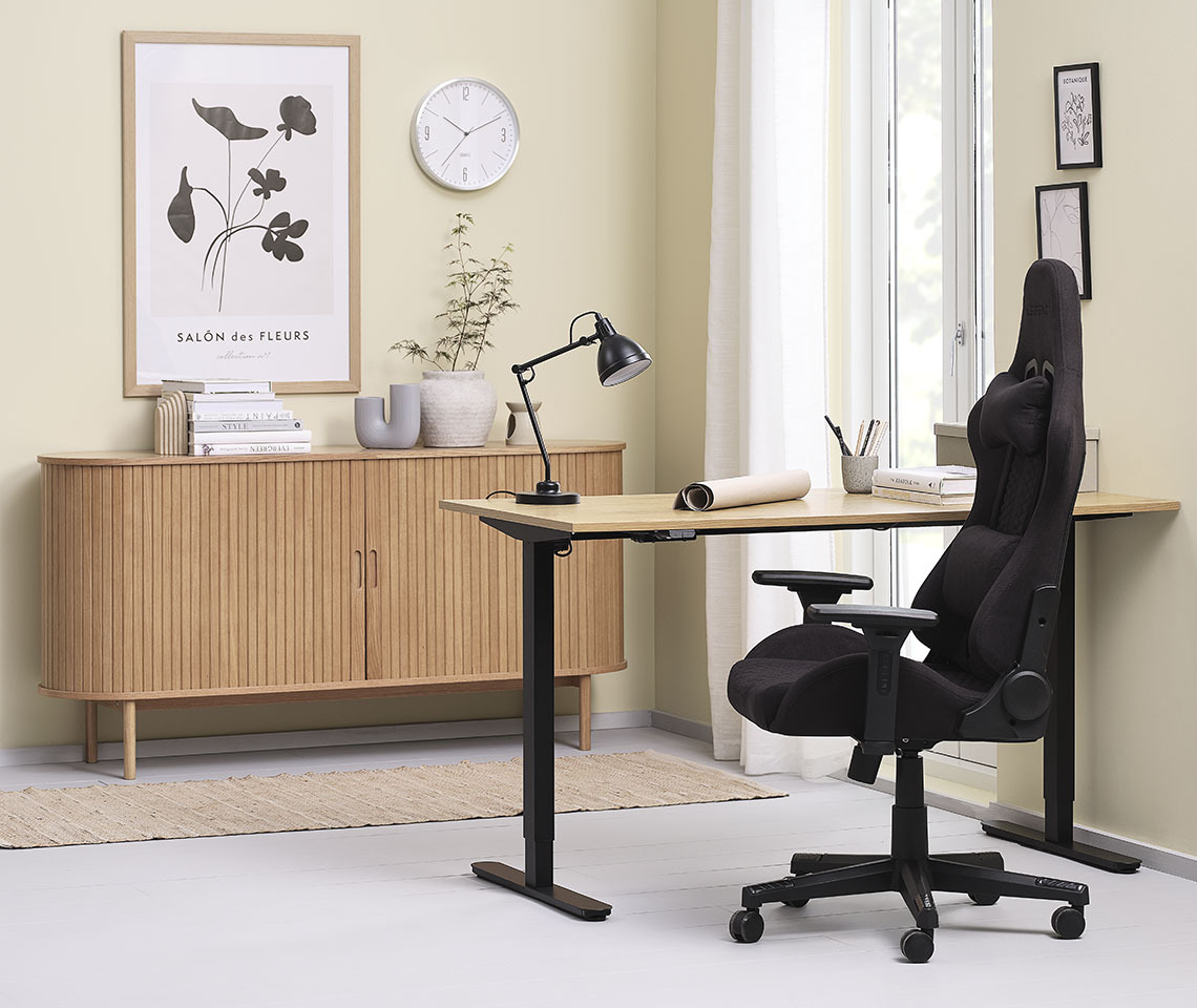 Cozy office décor with height-adjustable desk, gaming chair and sideboard