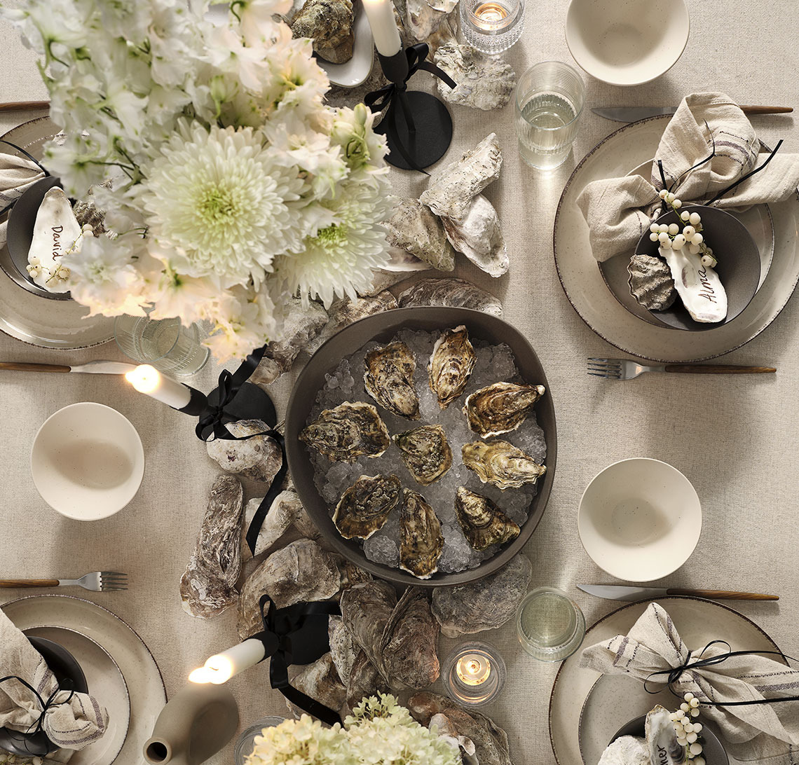 New Year’s Eve dinner party table with bowl of oysters 