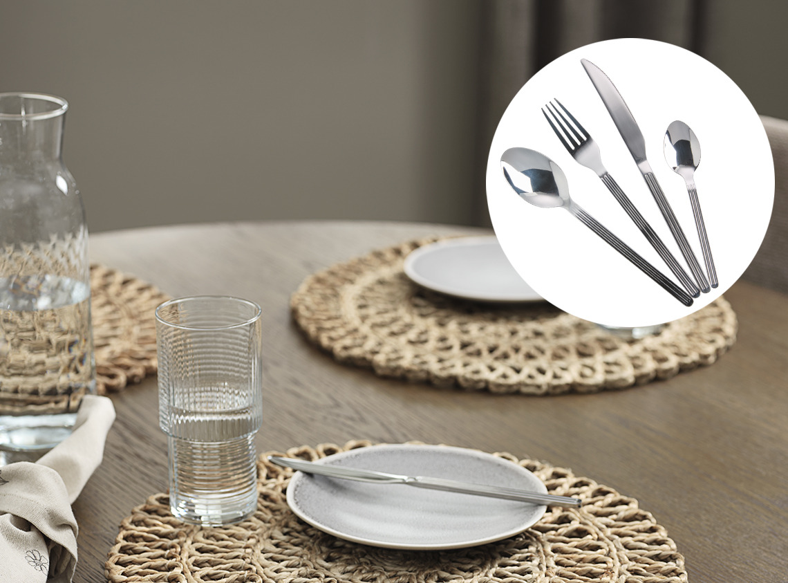 Table set with place mats, stoneware plates, drinking glasses and cutlery