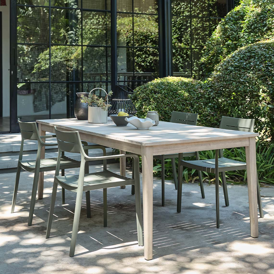 Hardwood garden table and four garden chairs on patio 